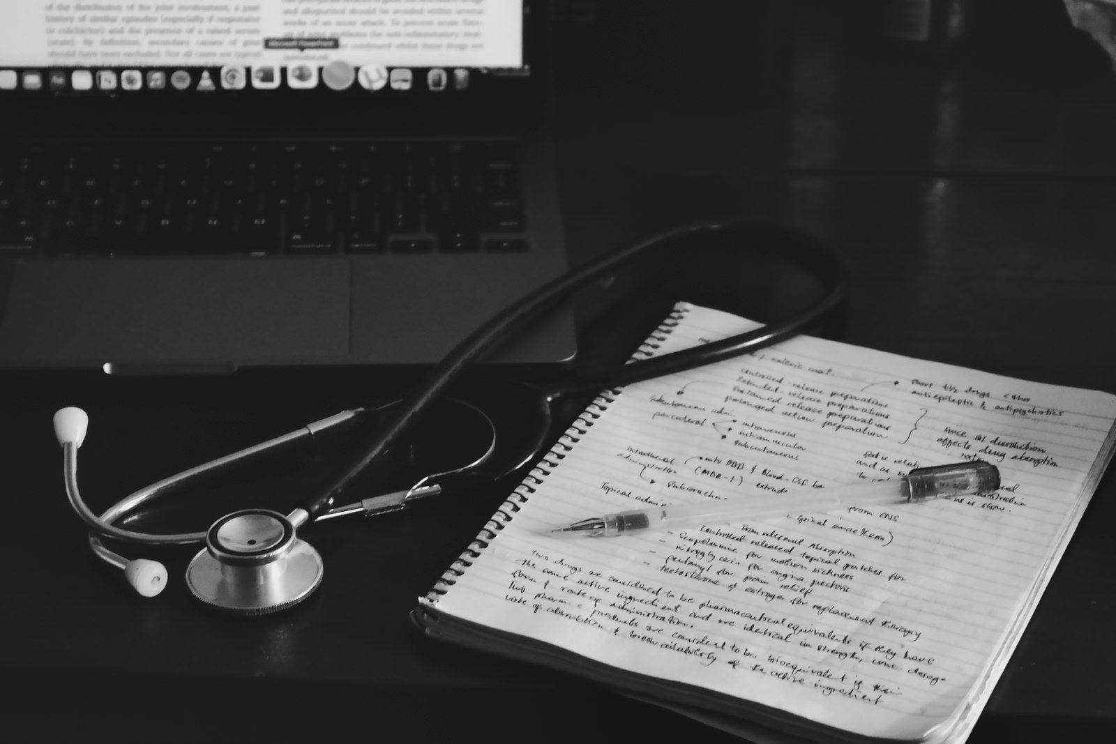 A stethoscope resting on an open notebook